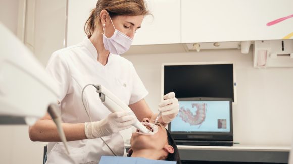 female dentist scanning teeth of woman 2021 10 27 03 18 50 utc scaled